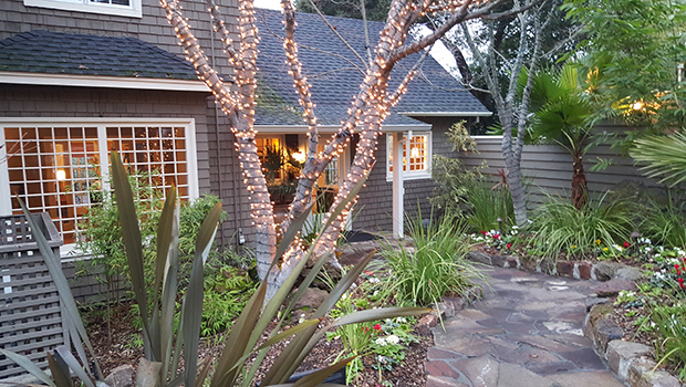Milliken Creek Inn & Spa- Entrance in Evenings are lit up with flowers lining sides of walkway.